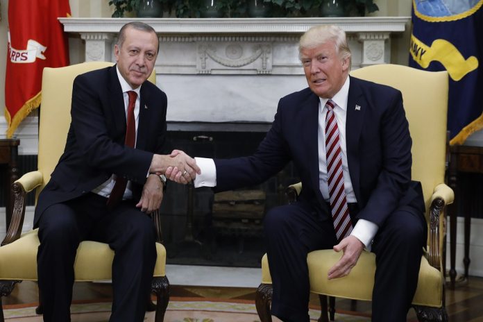 Turkey's President Erdogan shakes hands with U.S. President Trump in the Oval Office of the White House in Washington